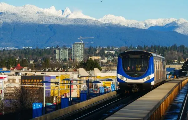 richmond-train-on-tracks-in-city-with-mountains-in-background-joel-janitorial-cleaning-services-inc